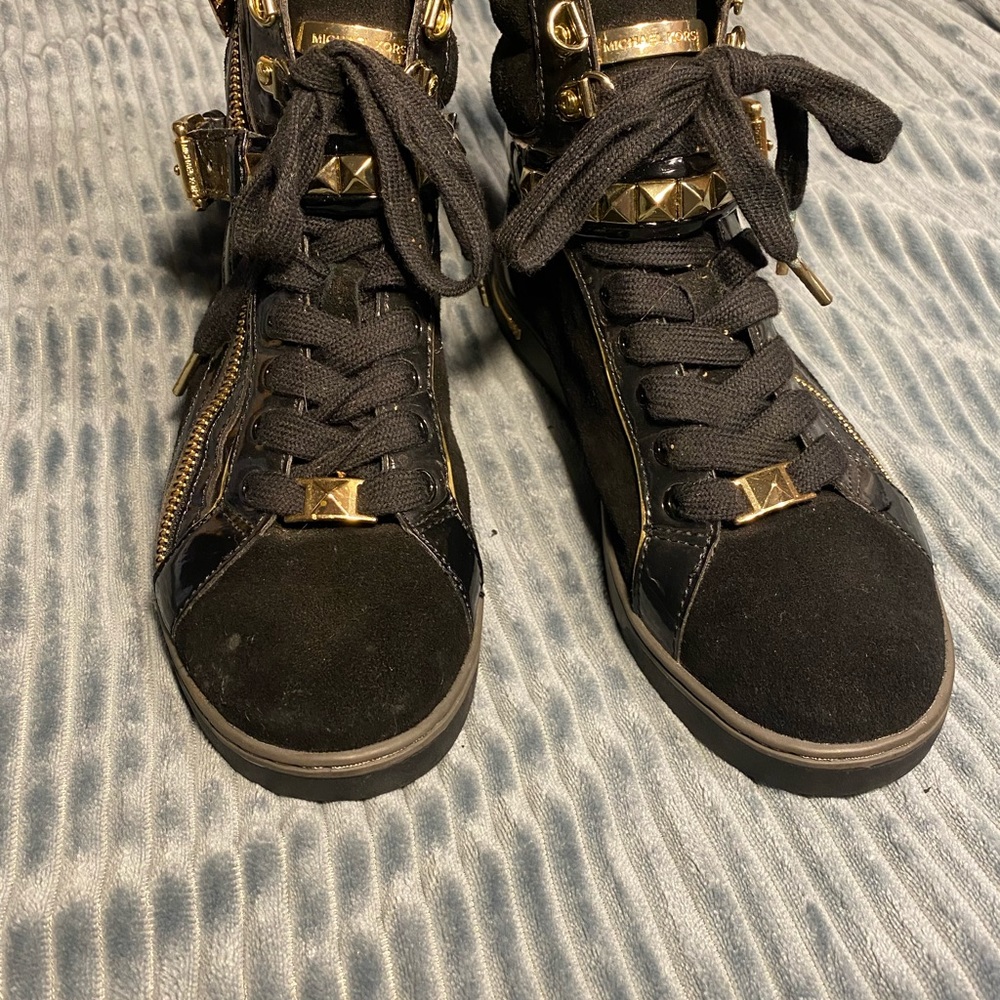 Black and gold Michael Kors high tops with studded accents and zippers
